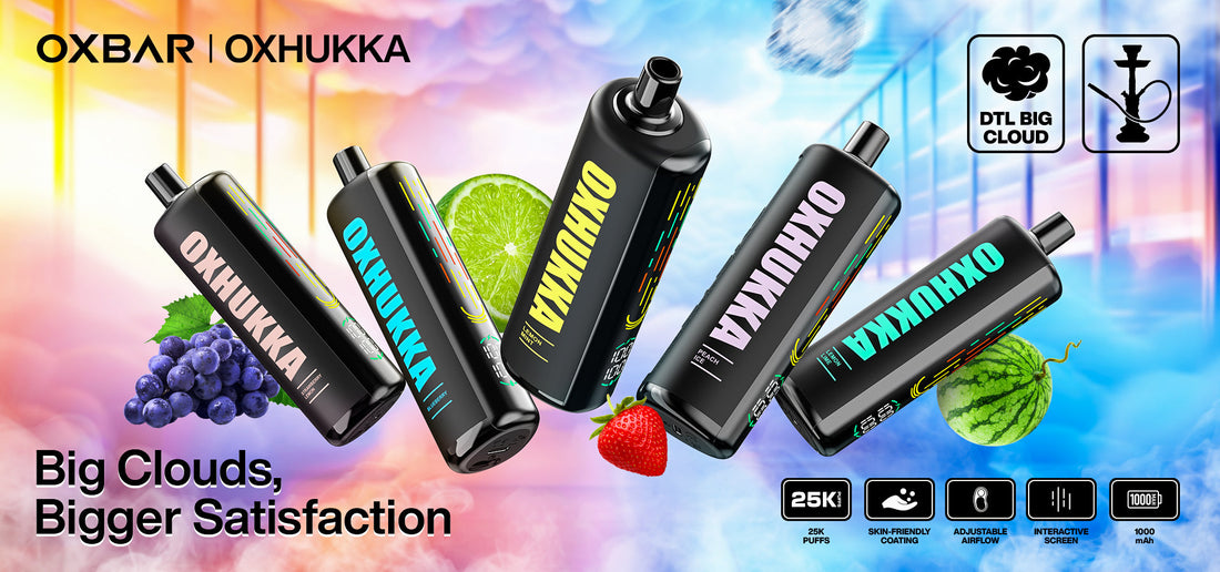 Five black vape devices with colorful "OXHUKKA" branding float against a vibrant, dreamy backdrop. Fruits like grapes and lime accent the scene. Text reads "Big Clouds, Bigger Satisfaction."
