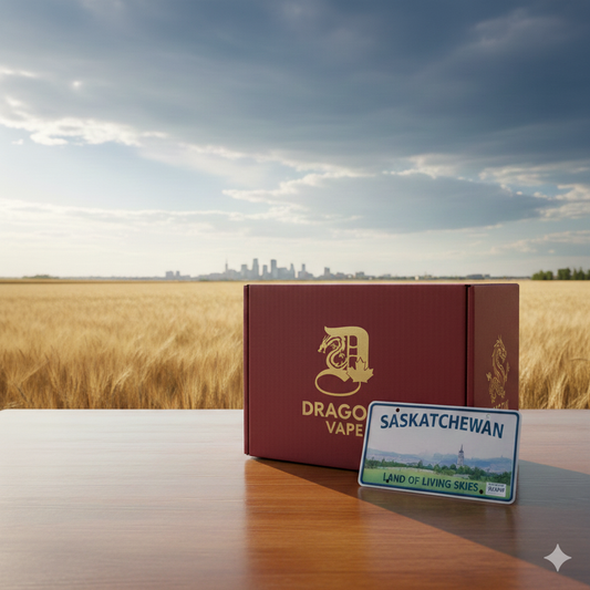 A red "Dragon Vape" box and a Saskatchewan license plate rest on a wooden table in a wheat field, with a city skyline under a partly cloudy sky.