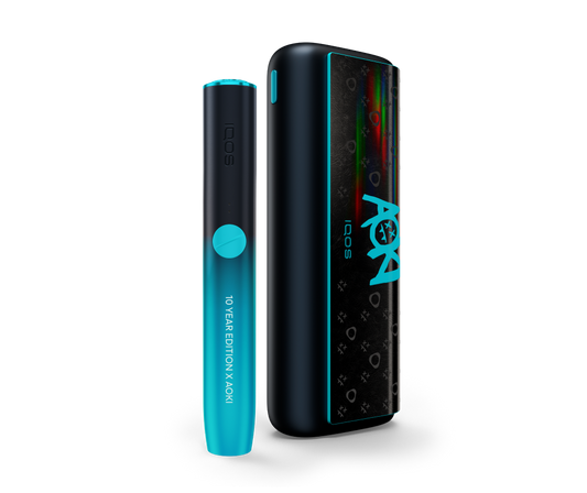Sleek black and turquoise IQOS device featuring "10 Year Edition X Aoki" text and vibrant rainbow accents. Modern, stylish, and celebratory design