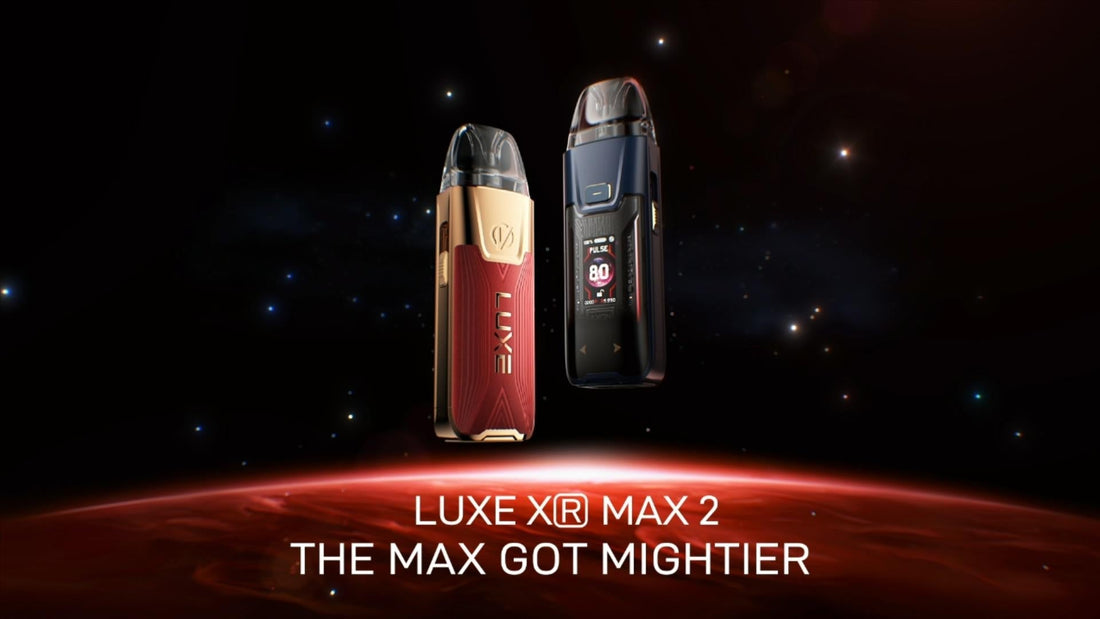 Two sleek vape devices, one in gold and red and the other in black, hover above a glowing red planet. Starry space background, text reads "Luxe XR Max 2, The Max Got Mightier.