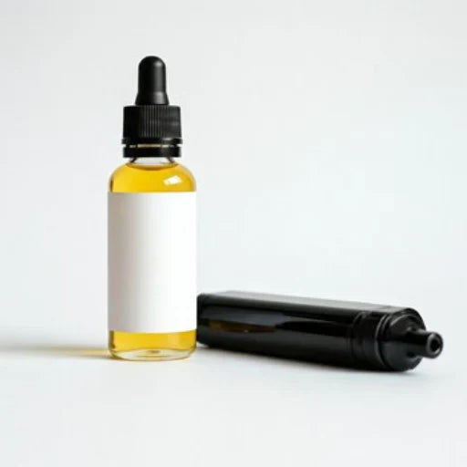 A clear dropper bottle filled with yellow liquid stands upright next to a black cylindrical bottle. Both containers have blank white labels.