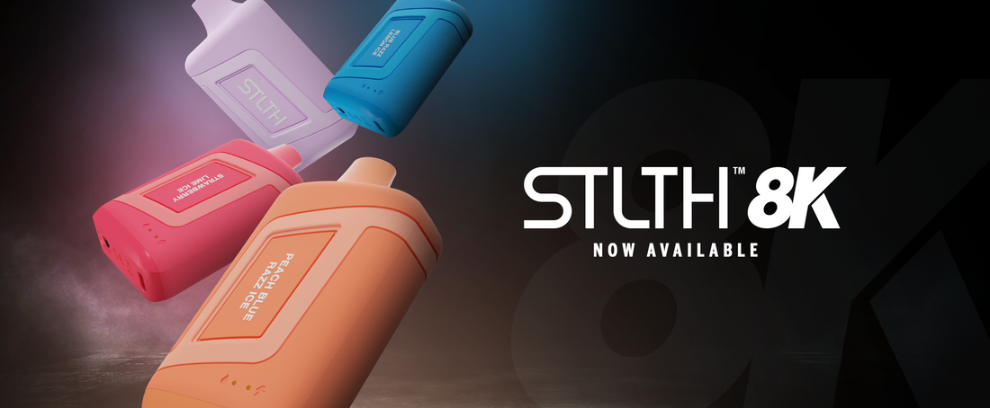 Colorful vape devices in pink, orange, lavender, and blue float against a dark, misty background. Bold text reads "STLTH 8K NOW AVAILABLE."